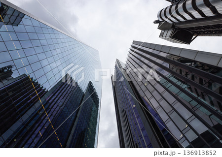Modern skyscrapers towering into a cloudy sky in a financial district 136913852