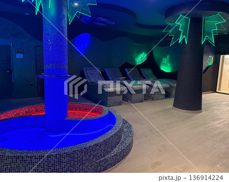 Spa relaxation area with mosaic loungers and neon accent lighting. Wellness leisure, body recovery and modern resort interior Spa relaxation area with mosaic loungers and neon accent lighting. Wellness leisure, body recovery and modern resort interior 136914224