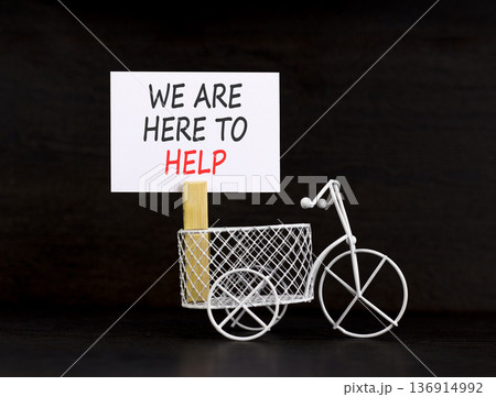 Support, help and we are here to help symbol. Concept words We are here to help on beautiful paper. Beautiful black background. Miniature bicycle. Business we are here to help concept. Copy space. Support, help and we are here to help symbol. Concept words We are here to help on beautiful paper. Beautiful black background. Miniature bicycle. Business we are here to help concept. Copy space. 136914992