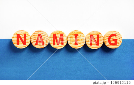 Naming or name symbol. Concept word Naming on beautiful wooden circles. Beautiful blue and white background. Business naming or name concept. Copy space. 136915116