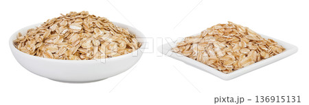 Oat flakes in ceramic bowl isolated on white background with full depth of field Oat flakes in ceramic bowl isolated on white background with full depth of field 136915131