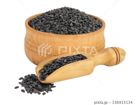 black sesame seeds in wooden bowl and scoop isolated on white background with full depth of field 136915134