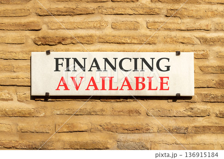 Financing available symbol. Concept words Financing available on beautiful big white sign plate. Beautiful old brown brick wall background. Business financing available concept. Copy space. Financing available symbol. Concept words Financing available on beautiful big white sign plate. Beautiful old brown brick wall background. Business financing available concept. Copy space. 136915184