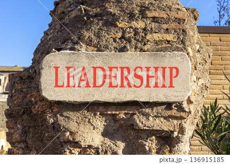 Leadership symbol. Concept word Leadership on beautiful white marble sign plate. Beautiful ancient brick wall background. Business leadership concept. Copy space. Leadership symbol. Concept word Leadership on beautiful white marble sign plate. Beautiful ancient brick wall background. Business leadership concept. Copy space. 136915185
