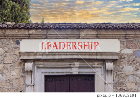 Leadership symbol. Concept word Leadership on beautiful white marble sign plate. Beautiful ancient stone wall and sunset background. Business leadership concept. Copy space. 136915191
