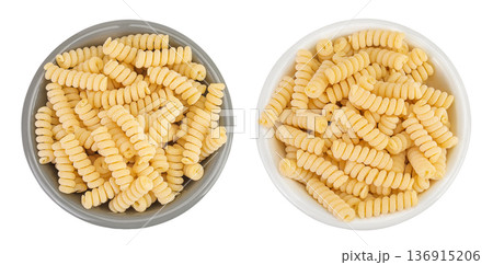 Italian spiral shaped pasta, Fusilli bucati macaroni in ceramic bowl, isolated on white background. Top view. Flat lay. 136915206
