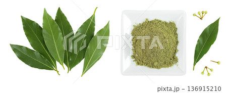 Fresh and ground Laurel leaves in ceramic bowl isolated on white background. Green bay leaf. Top view. Flat lay. Fresh and ground Laurel leaves in ceramic bowl isolated on white background. Green bay leaf. Top view. Flat lay. 136915210