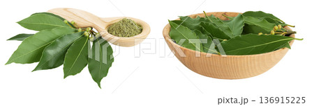 Fresh and ground Laurel leaves in wooden spoon and bowl isolated on white background. Green bay leaf 136915225