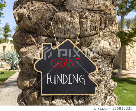 Grant funding symbol. Concept words Grant funding on beautiful black blackboard. Beautiful palm tree background. Business and grant funding concept. Copy space. Grant funding symbol. Concept words Grant funding on beautiful black blackboard. Beautiful palm tree background. Business and grant funding concept. Copy space. 136915226