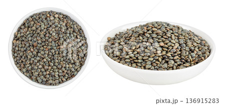 raw french green lentils in ceramic bowl isolated on white background. Top view. Flat lay raw french green lentils in ceramic bowl isolated on white background. Top view. Flat lay 136915283