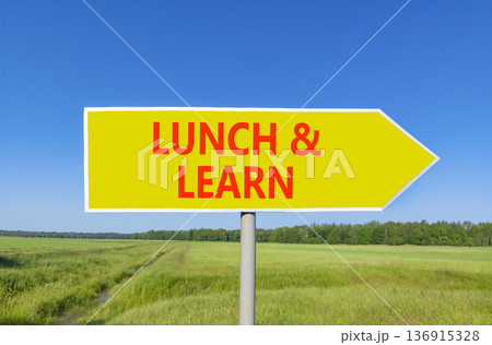 Lunch and learn symbol. Concept words Lunch and learn on beautiful yellow road sign. Beautiful blue sky green grass field background. Business, educational and lunch and learn concept. Copy space. 136915328