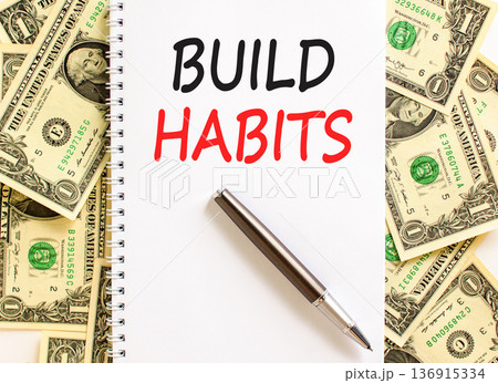 Build habits symbol. Concept word Build habits on beautiful white note. Dollar bills. Beautiful dollar bills background. Black pen. Business build habits concept. Copy space. Build habits symbol. Concept word Build habits on beautiful white note. Dollar bills. Beautiful dollar bills background. Black pen. Business build habits concept. Copy space. 136915334