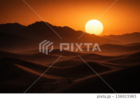 Dramatic desert landscape with sand dunes and glowing sunset over mountains Dramatic desert landscape with sand dunes and glowing sunset over mountains 136915965