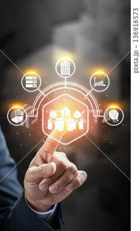 Businessman touching a futuristic digital interface with HR, teamwork, data analytics, and global networking icons. Ideal for business, leadership, and technology concepts 136916573