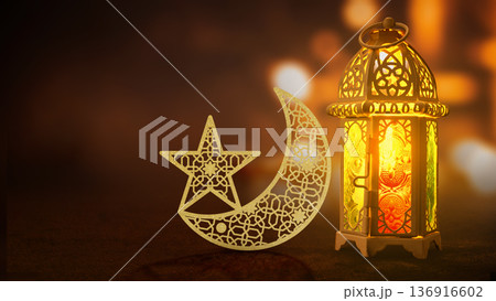 Beautiful glowing lantern and decorative golden crescent moon with star for Ramadan or Eid celebration. Warm bokeh background with copy space 136916602