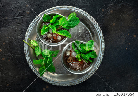 Mint Julep in the Kentucky Derby classic silver glass, with fresh mint leaves 136917054