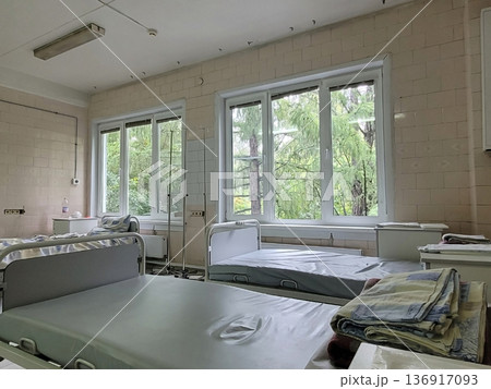 Empty hospital room with beds in a recovery ward. Medical facility interior for patient care and healthcare concept. Empty hospital room with beds in a recovery ward. Medical facility interior for patient care and healthcare concept. 136917093