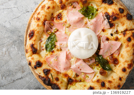 Hot Italian pizza with mortadella and burrata cheese close-up on a wooden board. Horizontal top view 136919227