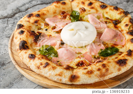 Authentic Italian pizza with mortadella sausage and burrata cheese, close-up, on a wooden board. Horizontal Authentic Italian pizza with mortadella sausage and burrata cheese, close-up, on a wooden board. Horizontal 136919233