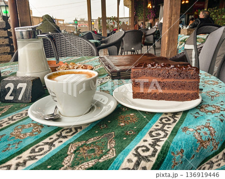A cup of coffee and a slice of cake in a cafe in Erbil, Iraq A cup of coffee and a slice of cake in a cafe in Erbil, Iraq 136919446