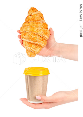 Female hands holding croissant and takeaway coffee cup Female hands holding croissant and takeaway coffee cup 136919709