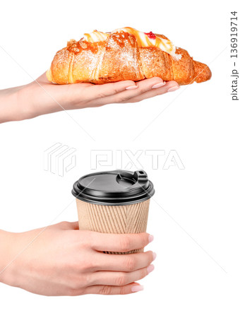 Croissant and takeaway coffee in hands isolated on white background 136919714