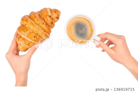 Female hands holding croissant and cup of coffee isolated on white background Female hands holding croissant and cup of coffee isolated on white background 136919715