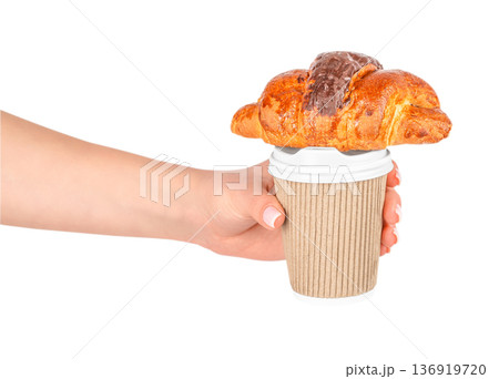Woman holding takeaway coffee with chocolate croissant Woman holding takeaway coffee with chocolate croissant 136919720