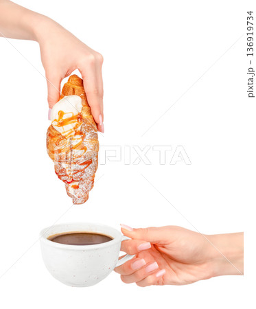 Croissant with caramel and cream dripping above cup of coffee isolated on white background Croissant with caramel and cream dripping above cup of coffee isolated on white background 136919734