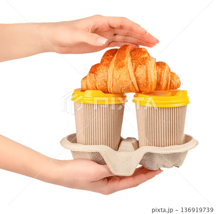 Two takeaway coffee cups with croissant in cardboard carrier Two takeaway coffee cups with croissant in cardboard carrier 136919739