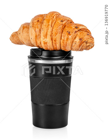 Croissant on black reusable coffee cup isolated on white background 136919770