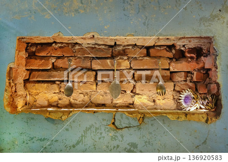 The design element, a brick wall with three spoons hanging from it The design element, a brick wall with three spoons hanging from it 136920583