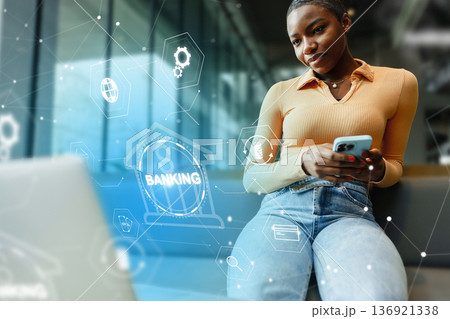 Person using smartphone for banking invoice payment in modern office setting 136921338