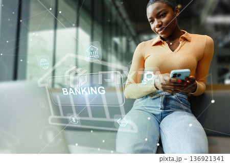 Woman using phone for banking invoice payment in modern office setting 136921341