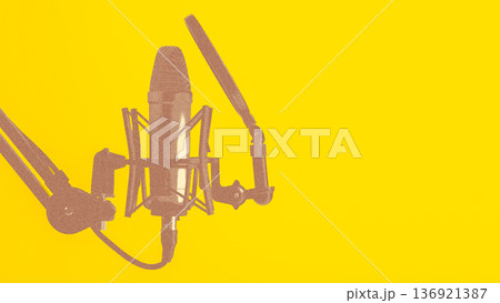 Podcast microphone setup with yellow background for recording sessions 136921387