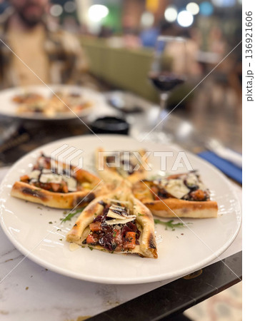 Gourmet appetizers served on a white plate in elegant restaurant setting. Fine dining, culinary aesthetics, and food presentation. 136921606