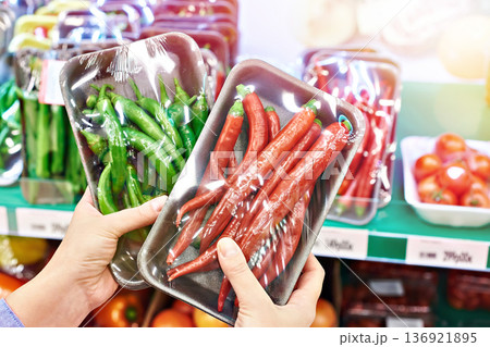 Buyer with chili peppers in store Buyer with chili peppers in store 136921895