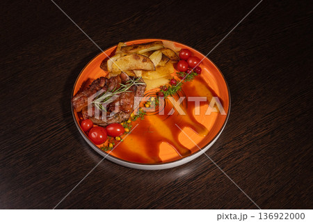 Fried potatoes with a piece of meat on a plate Fried potatoes with a piece of meat on a plate 136922000