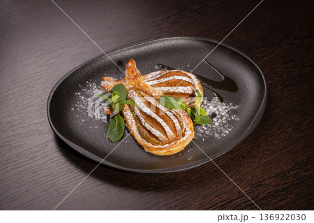 Dessert of fried pear sprinkled with powdered Dessert of fried pear sprinkled with powdered 136922030