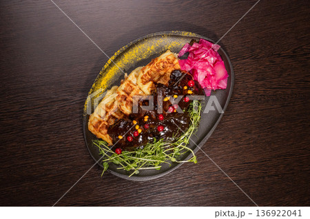 Fried meat with potato waffles and herbs on a Fried meat with potato waffles and herbs on a 136922041