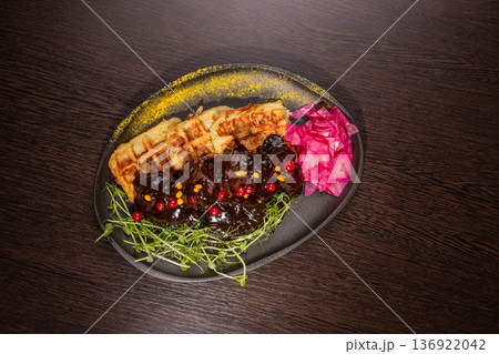 Fried meat with potato waffles and herbs on a Fried meat with potato waffles and herbs on a 136922042