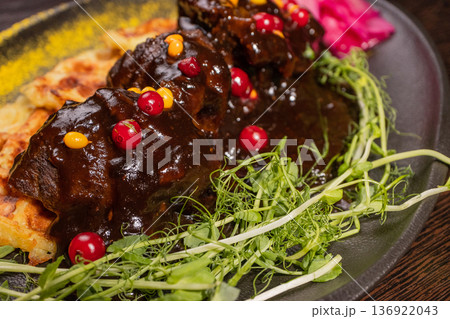 Fried meat with potato waffles and herbs on a 136922043
