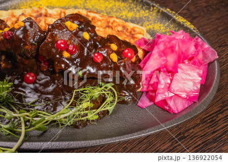 Fried meat with potato waffles and herbs on a Fried meat with potato waffles and herbs on a 136922054