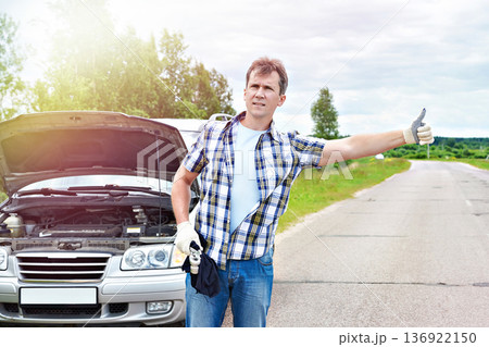 Man waiting to help and showing thumbs up near car Man waiting to help and showing thumbs up near car 136922150