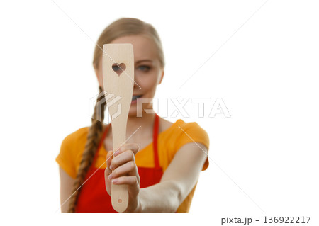 Woman holding wooden spatula with heart Woman holding wooden spatula with heart 136922217