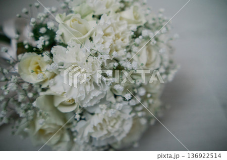 A wedding bouquet lies on a white parquet floor 136922514