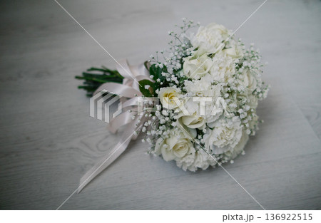 A wedding bouquet lies on a white parquet floor A wedding bouquet lies on a white parquet floor 136922515