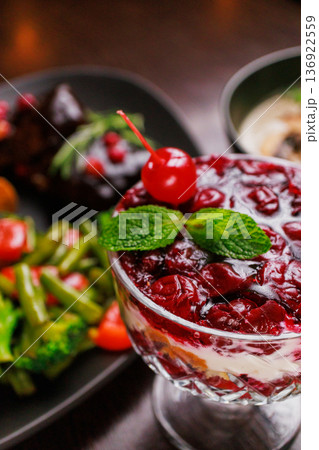 Dessert of pickled cherries with cream in a glass Dessert of pickled cherries with cream in a glass 136922559