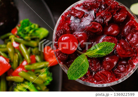 Dessert of pickled cherries with cream in a glass Dessert of pickled cherries with cream in a glass 136922599