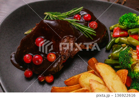A plate of fried meat, fried potatoes and A plate of fried meat, fried potatoes and 136922616